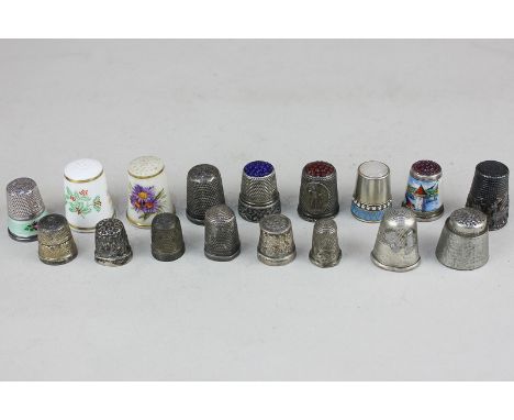 A collection of fifteen white metal thimbles, some with enamel designs, together with two Royal Worcester porcelain thimbles