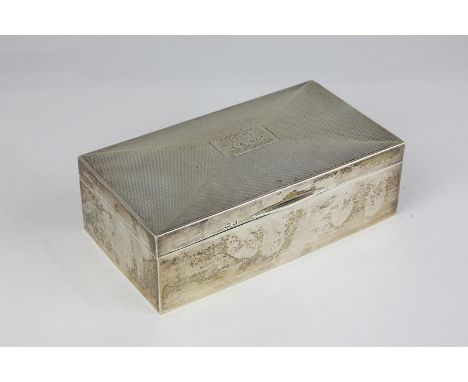 A George V silver rectangular cigarette box with engine turned decoration, lid with engraved initials and dated, maker Barker