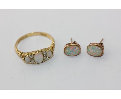 An opal and diamond ring set with three graduated oval cut opals with trios of small old cuts between, Birmingham 1901; and a