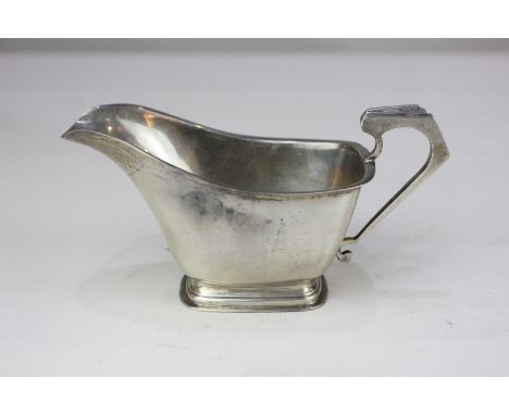 An Edward VIII Art Deco silver cream jug on rectangular foot, maker William Neale, Birmingham 1936, 3.5oz, 15cm