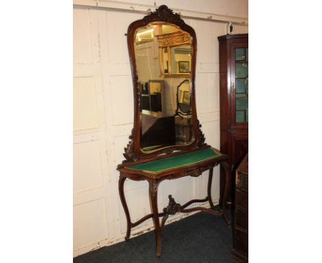 A Louis XV style carved mahogany wall mirror, cartouche shape with shell surmount, above associated console table with baize 