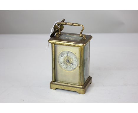 A gilt brass and bevelled glass cased carriage clock, the circular silvered dial with gilt surround (a/f), 14cm high