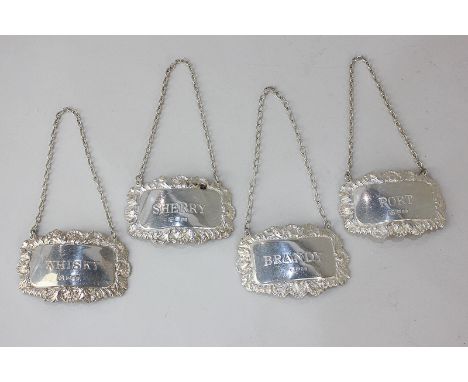 A set of four modern silver decanter labels marked Port, Whisky, Brandy and Sherry, with shell and scroll borders, London 197