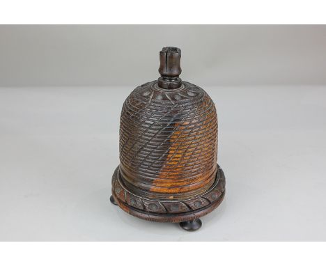 A 19th century wooden treen string box in the form of a beehive, with cutting blade finial, 18cm high
