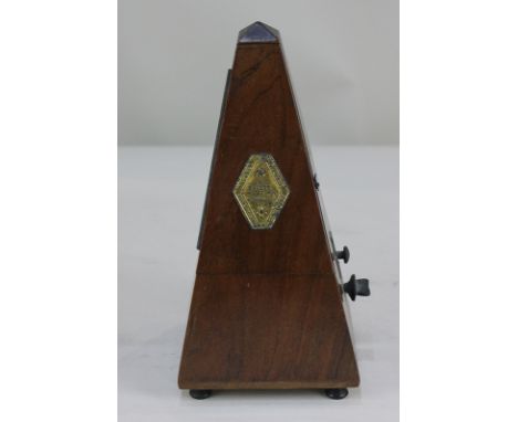A French metronome in pyramid shape case, bears brass plaque for Maelzel Paquet, 22.5cm high