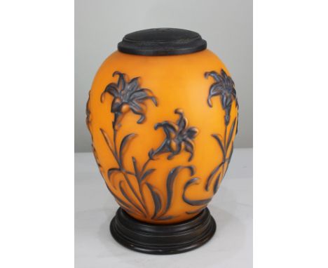 An orange glass table lamp in the form of a Chinese lantern, decorated with lilies, on circular wooden base (a/f), 31cm