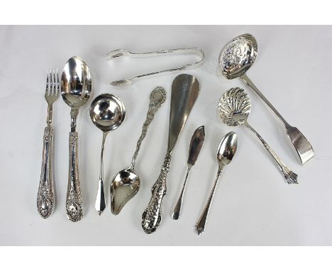 A collection of Victorian and later silver servers including two sugar sifters, sugar tongs, pickle fork, shoe horn, four var