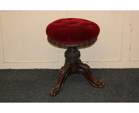 A Victorian piano stool with circular adjustable seat on tripod base and claw feet (a/f)