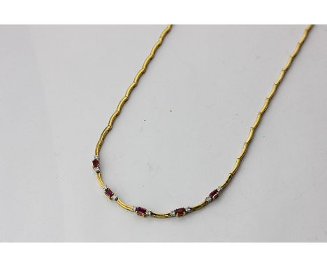 A ruby and diamond necklace claw set with five step cut rubies flanked by small brilliant cuts on a crescent link lock chain 