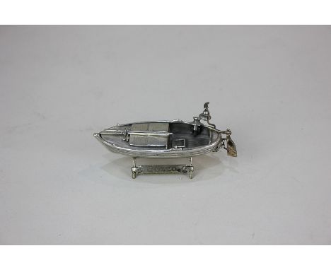 An Italian 800 silver model of a rowing boat, made in Arezzo Province, on matching stand engraved Gozzo, 8cm long