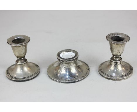 A pair of George V silver dwarf candlesticks, maker Boots Pure Drug Company, Birmingham, 1911, together with a silver inkwell