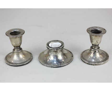 A pair of George V silver dwarf candlesticks, maker Boots Pure Drug Company, Birmingham, 1911, together with a silver inkwell