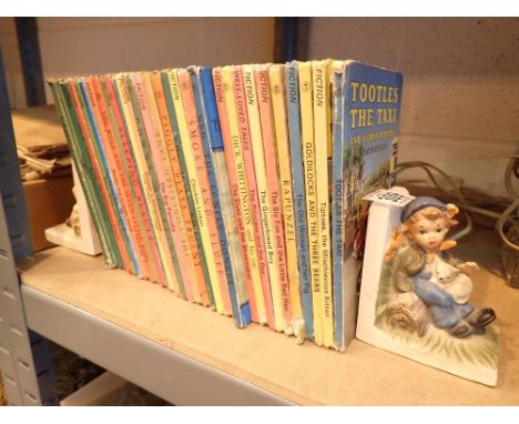 Ladybird books between a pair of German ceramic bookends