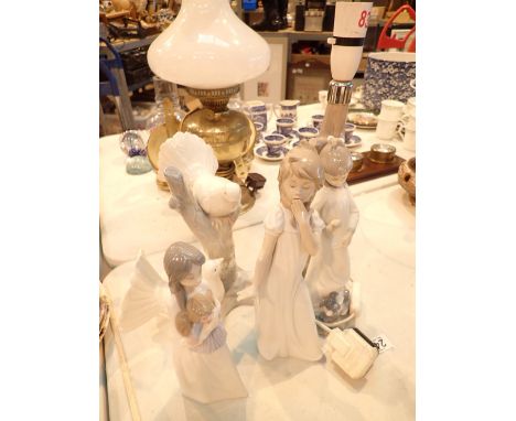 Four pieces of Nao including a figural table lamp