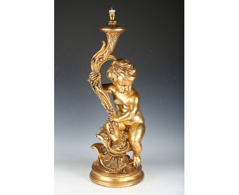 A 20th century gilt plaster figural table lamp, modelled as a putto holding a cornucopia, raised on a circular base, height 7