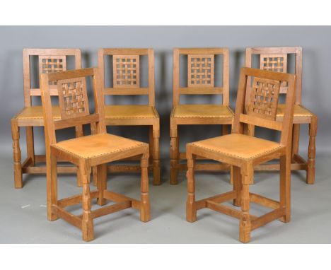 A set of six Robert 'Mouseman' Thompson workshop oak dining chairs with carved lattice backs and tan leather seats, each chai