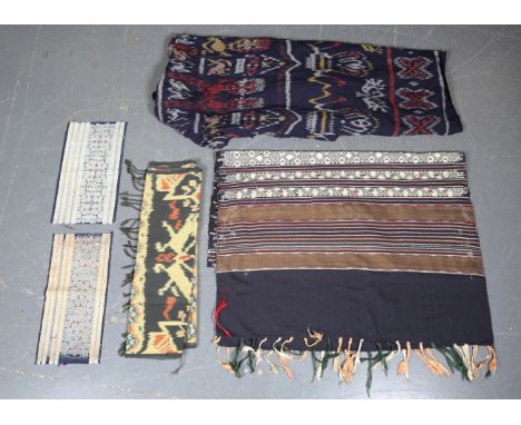 A Sumba Ikat panel, Indonesia, woven with two bands of ancestral figures, 210cm x 117cm, a long Ikat border woven with bands 