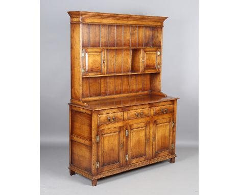 A modern reproduction solid oak dresser, the shelf back above drawers and cupboards, height 187cm, width 135cm, depth 49cm.Bu
