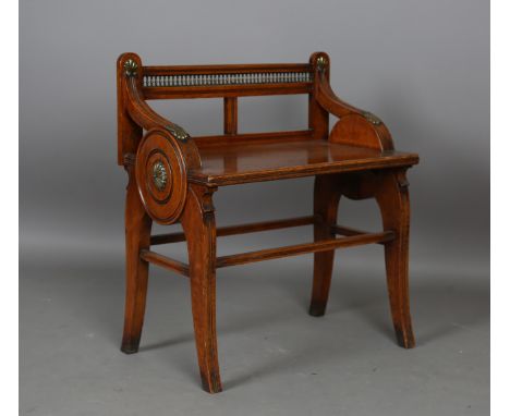 A late Victorian oak hall seat by James Shoolbred &amp; Co, each low arm and circular panel side with brass mounts, raised on