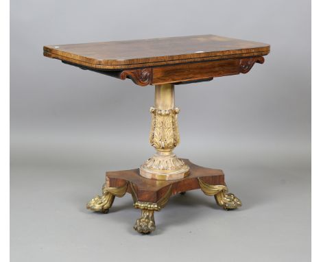 A Regency rosewood fold-over card table with a giltwood and gesso carved stem and cast gilt brass claw feet, height 74cm, wid