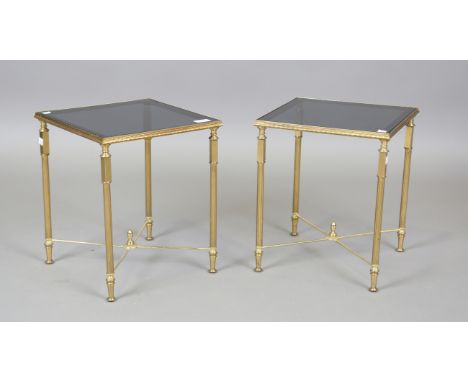 A pair of mid/late 20th century gilt brass lamp tables with smoky glass tops, height 38cm, width 32cm.Buyer’s Premium 29.4% (
