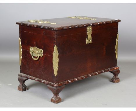 A 20th century South African hardwood and brass mounted trunk, raised on cabriole legs, height 70cm, width 97cm, depth 56cm.B
