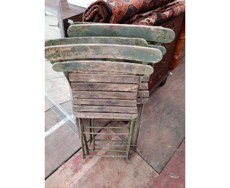 A set of four early 20th century teak and elm iron folding garden chairs each 46cm wideCondition report: Surface rust, moss a