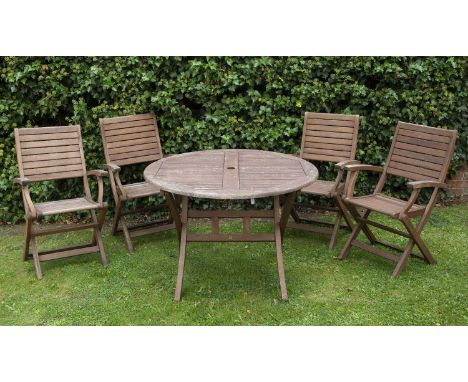 A modern circular teak folding garden table and four matching chairs with armrests, table 100cm diameter x 74cm high, chairs 