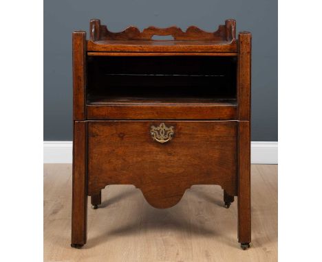A George III mahogany commode with galleried top above a recess with pull out slide and a commode drawer later fitted with le