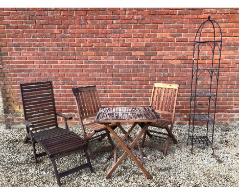 A five tier black painted cast iron plant stand the open bird cage style top with acorn finial over strapwork removable shelv