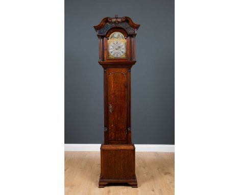 A George III unusual sized oak eight day longcase clock, the hood with swan neck pediment, blue backed glazed panels with pai