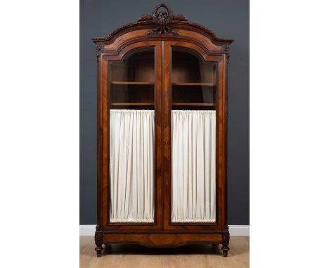 A 19th century Louis XVI style rosewood two door armoire, the glass fronted doors with internal half height curtains flanked 