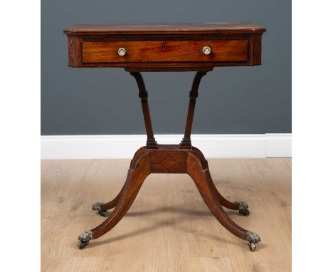 A George III mahogany reading table the rectangular tilting top with canted corners and ebony stringing, with single frieze d