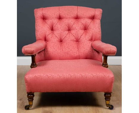 A Howard-style low open armchair with pink button backed upholstered seat and arm rests, stamp no. 4930 to base with turned l