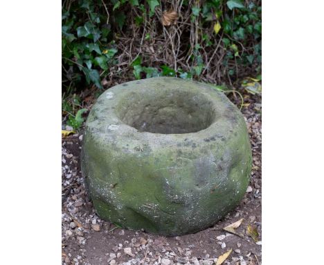 An ancient limestone "Knocker" or Scottish ponding mortar, Iron age or Celtic period, found in the borders, 37cm diameter x 2