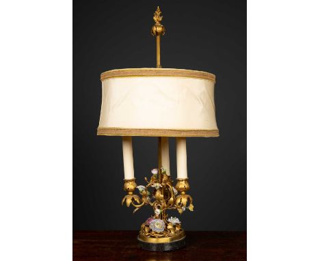 A decorative table lamp constructed from a 19th century gilt metal three branch candelabrum, applied with porcelain flowers, 