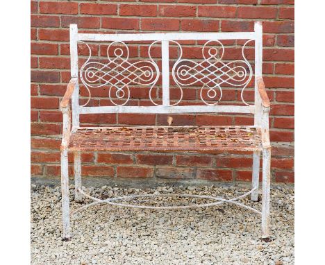 A white painted cast iron two seater garden bench, the geometric decorated back above strapwork seat, 101cm wide x 4.6cm deep