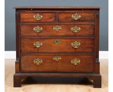 A George III mahogany small chest of two short and three long drawers with fluted quarter pilaster columns to the front corne
