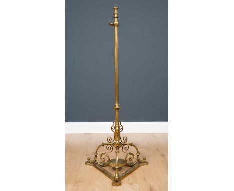 A late 19th century brass adjustable standard lamp with a triform base, 40cm wide at the base x 110cm high at lowest levelCon