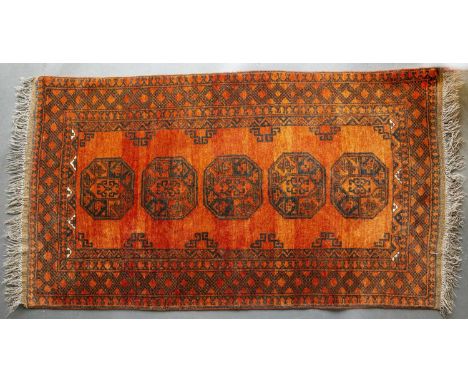 A late 20th century Eastern red, yellow and blue ground runner with geometric decoration, 330cm x 84cm and a mid to late 20th