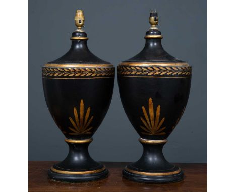 A pair of black painted parcel gilt ceramic table lamps in the form of classical vases, each 23cm diameter x 53cm high overal