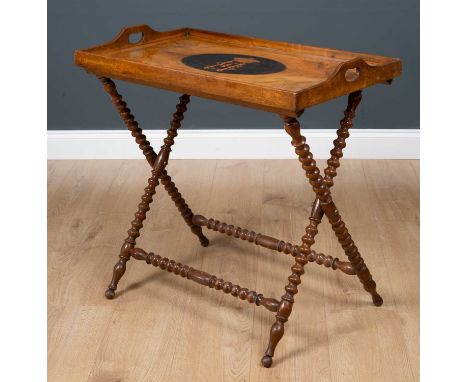 A Victorian olive wood tray complete with folding bobbin turned stand, the quarter veneered tray with central ebonised oval a
