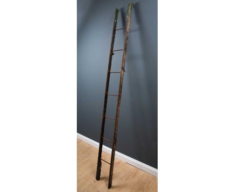 A 19th Century oak and wrought iron folding library ladder previously painted green and with wrought iron hooks to the top, 9
