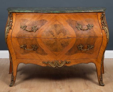 A marble topped bombe shaped commode with gilt metal mounts and fittings and figured walnut inset panels, the green marble to