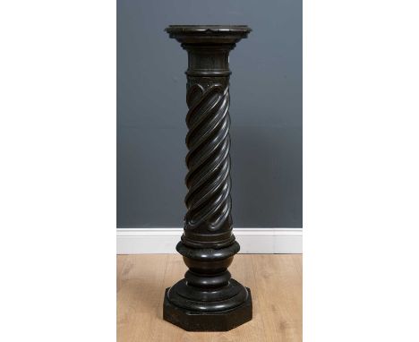 A black and green speckled marble classical style column, the circular pedestal on fluted spiral column and stepped octagonal