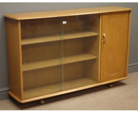 Ercol style sideboard with sliding glass doors enclosing two shelves, single cupboard door to the side, W137cm, H87cm, D37cm 