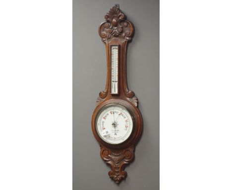 Early 20th century carved oak cased aneroid barometer with thermometer, H91cm Condition Report Click here for further images,