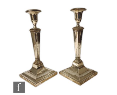 A pair of Victorian silver hallmarked candlesticks, the stepped square base rising to a tapered stem and campana urn form can