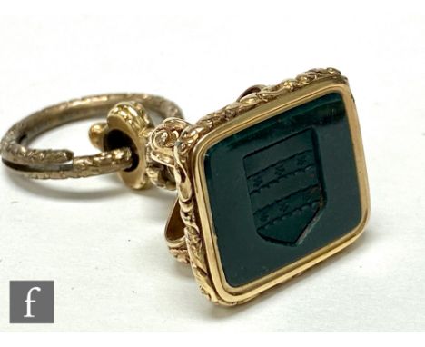 A 19th Century intaglio fob seal, the square section bloodstone seal carved with crest, surmounted by a stylised foliate scro