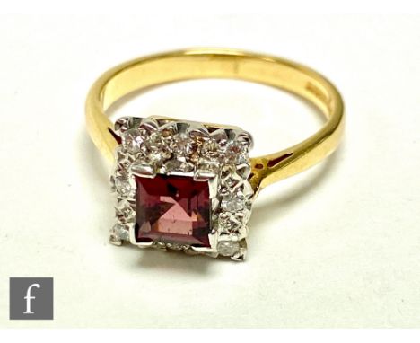 An 18ct hallmarked tourmaline and diamond cluster ring, central square cut tourmaline within a border of eight diamonds, weig